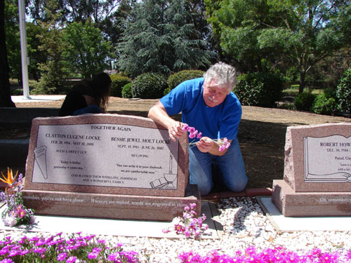 Bob freshening his mom's flowers with her beloved pinks that she transplanted to house after house during her life</i>