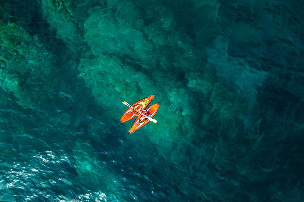 Orange canoes at sea