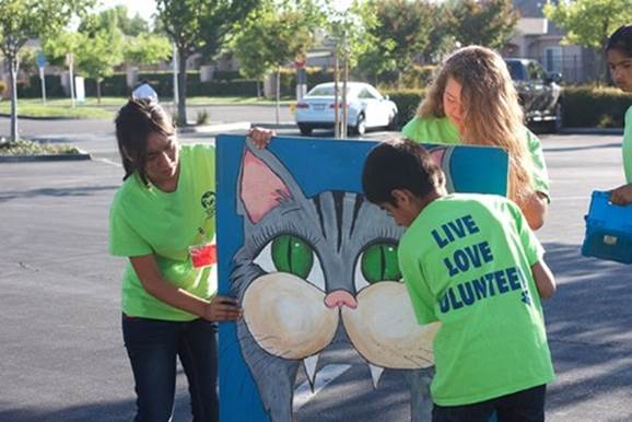 A group of people holding signs

Description automatically generated