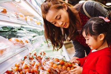 Mother and child picking tomatoes