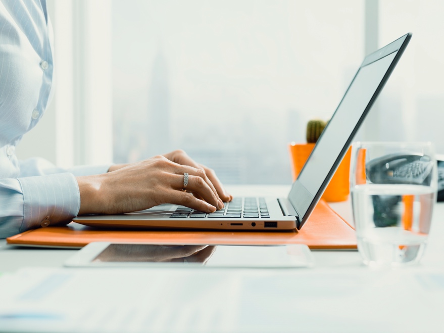 Worker typing on laptop