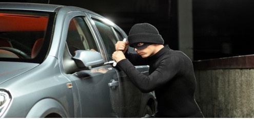 A person in a mask leaning on a car

Description automatically generated with low confidence