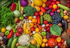 A bunch of different vegetables on display at a fruit stand

Description automatically generated